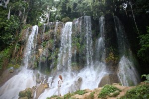 Girl standing in front of El Nicho waterfall, Cienfuegos Cuba