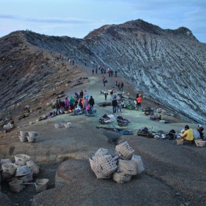 Tourists and sulphur miners on the lip of Kawah Ijen