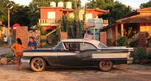 Classic car taxi with American flag in La Boca, Cuba
