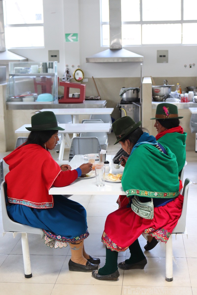 Indigenous Ecuadorian woman having lunch at the Mercado