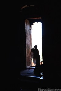 Ethiopian priest standing in the doorway of his church