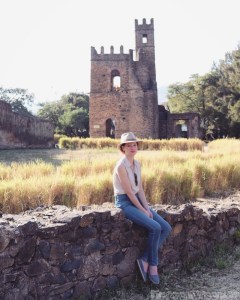 Sofie sitting on a wall in the Royal Enclosure, Gondar