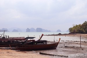 Fishing boats on a Koh Yao Noi beach at low tide