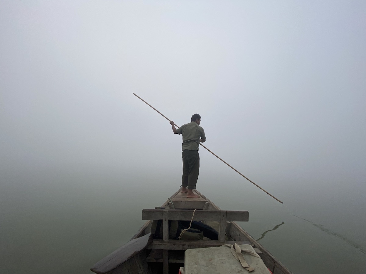 Boat crossing the misty river to Chitwan National Park Nepal