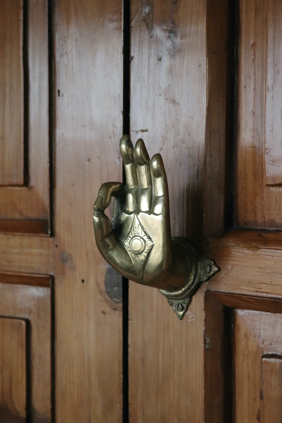 Door handle in the shape of a buddhist mudra hand